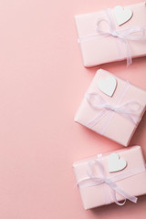 Obraz na płótnie Canvas Pink valentine gift frame layout with white hearts on a pastel pink background