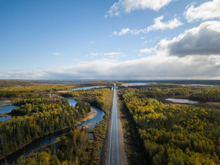 Aerial view of a scenic road during a beautiful sunny day in the Autumn. Taken near Grand Falls-Windsor, Newfoundland, Canada.