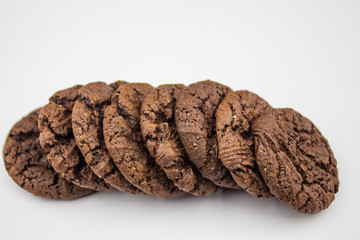 Chocolate cookies on wooden table. Chocolate chip cookies shot. Stacks of chocolate cookies, cookies with chocolate drops, cookies with oatmeal. Assorted cookies.