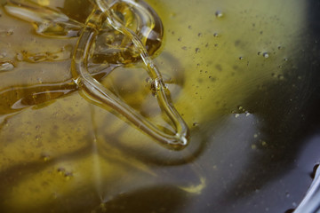 Texture of sweet stretching honey. Close-up and macro of honey bubbles.