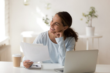 Smiling businesswoman, student with paper documents in hand thinking about business strategy,...