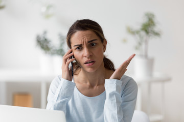 Upset unpleasantly surprised woman making phone call, disputing, complaining, having bad...