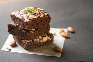 A stack of chocolate brownies on dark plat background ,homemade bakery and dessert.
