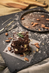A stack of chocolate brownies on dark plat background ,homemade bakery and dessert.