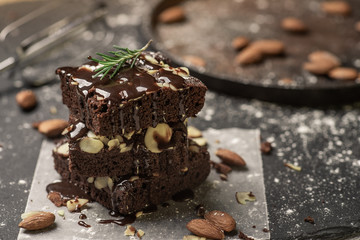 A stack of chocolate brownies on dark plat background ,homemade bakery and dessert.