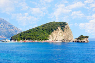 Fototapeta premium St. Nicholas island near Budva in Montenegro. Coast with blue sea, rocks and sky with clouds