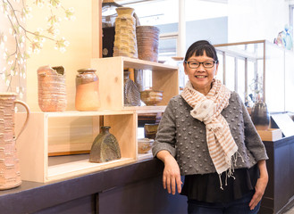 Smiling, happy, confident, successful Asian woman businesswoman small business owner