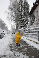 Child is walking on the winter street