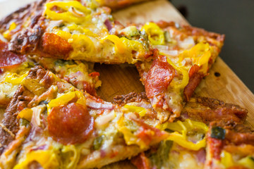 Pizza with Everything on Wood Background