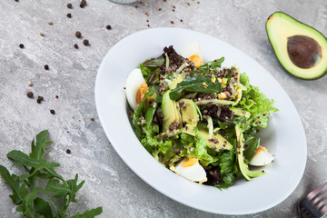 Close up view on salad with quinoa, avocado and egg on a concrete background. Healthy food. Spanish cuisine. free copy space for text, logo. Picture for recipe. Flat lay. 