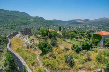 Medieval stone fortress is located high in the mountains.