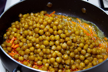 Peas in a pan with chopped carrots