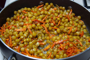 Peas in a pan with chopped carrots