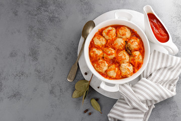 Fish meatballs in tomato sauce with carrot, top view