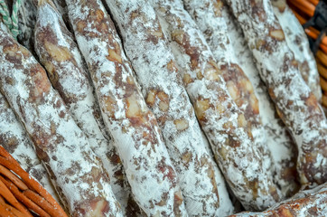 Close up of delicious Spanish meat sausages (fuet). Selective focus.
