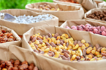 Nuts in paper boxes for sale in the market. Selective focus. Copy space.