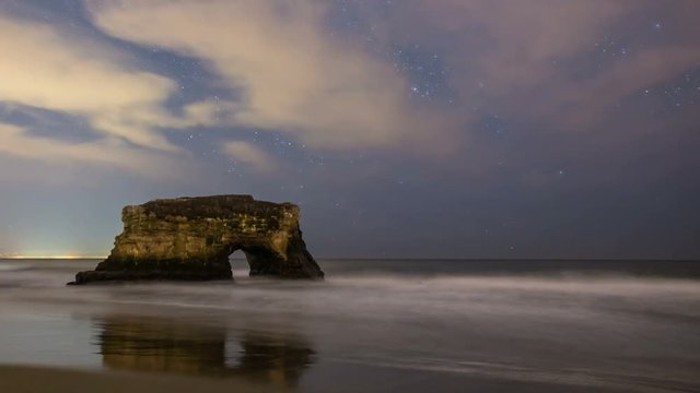 Astro Timelapse of Stars over Arch Rock Sea Cave in Santa Cruz -Pan Left-