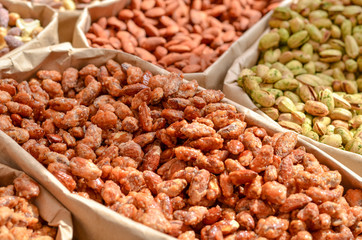 Assorted nuts in paper boxes for sale in the market. Selective focus. Copy space.