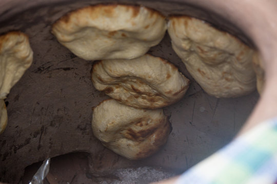 Making bread in tandoor oven