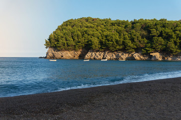 Fototapeta na wymiar White boats on the background of rocks, Montenegro