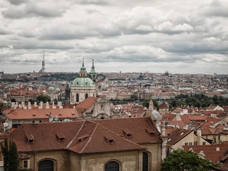 Obraz premium View to rooftops, dome of Saint Nicolas Cathedral and Zhizhkov TV Tower Prague Castle 