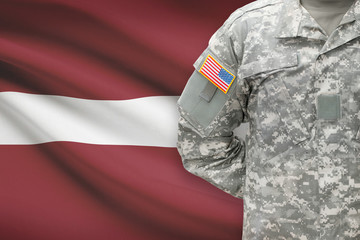 Fototapeta na wymiar American soldier with flag on background - Latvia