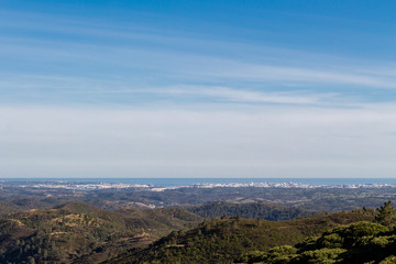Fototapeta na wymiar Beautiful nature landscape (panorama) and cityscape in Alentejo, Portugal. Beautiful hills and ocean in the far background.