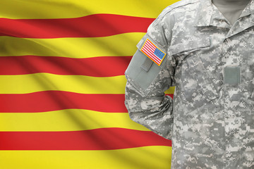 Fototapeta na wymiar American soldier with flag on background - Catalonia - Spain