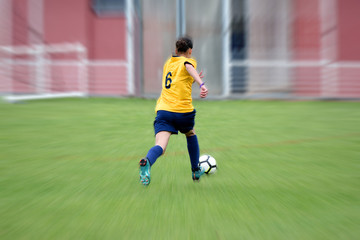 jeune femme jouant au football en plein match