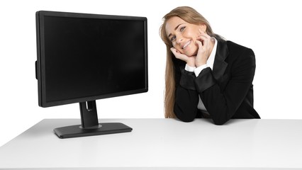 young woman posing beside a computer monitor