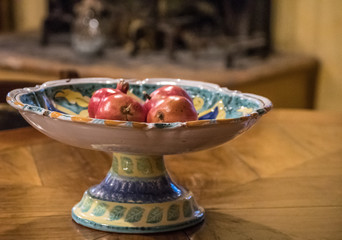 Fruit in Decorative bowl - overhead and depth of field. Pomegranates, grapes and plums - fresh and delicious