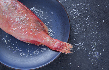 fish salt prepared seafood plate healthy food diet dark stone background