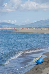 Basket of fishing nets on the beach, blue sky and beautiful Adriatic.