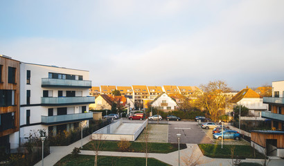 Above view of the interior courtyard of modern townhouses and homes in a residential area with multiple new apartments buildings surrounded by green outdoor facilities in central calm neighborhood