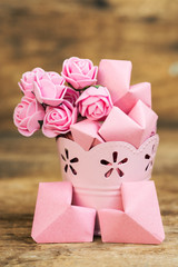 bouquet of flowers in rosy decorative bucket, note and space for text. Happy Valentine's Day card 