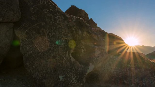 Timelapse Tracking Shot of Sunrise Illuminating Indian Petroglyphs -Pan Right-