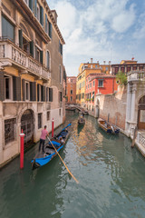 Fototapeta na wymiar Beautiful Canal in Venice and gondolier