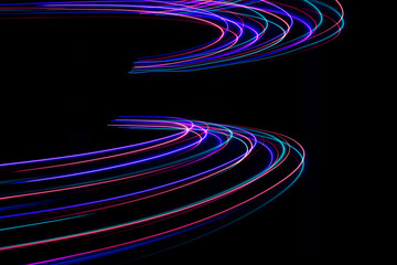 Lines of light on black background. Abstract design in the dark.