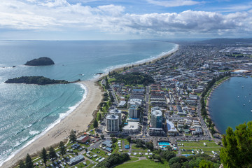 View from the summit of Mt Mauao volcano in Mount Maunganui, colloquially known as "The Mount". Panoramic view of the city and bay. Tauranga, Bay of Plenty, North Island, New Zealand. 