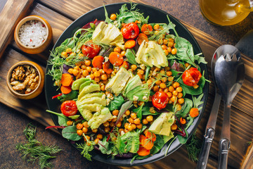 Avocado, roasted tomato, greens and chickpeas salad