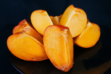 Persimmon fruits cut into slices.