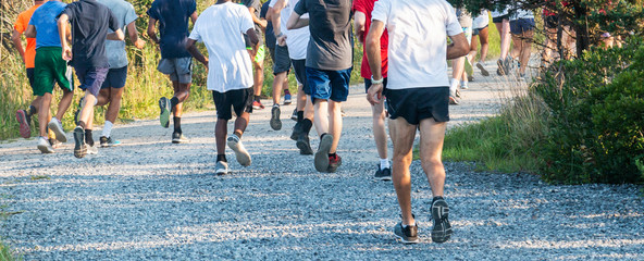 Runners on gravel shot from behind