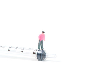 Miniature people, small figure old man or patient with a big syringe, isolated on white background, healthy concept. © pookpiik