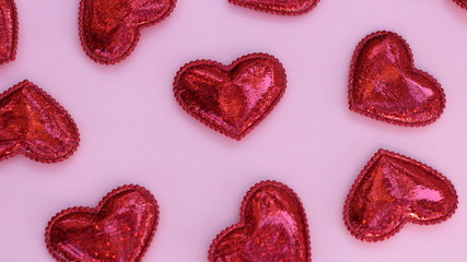 group of red 3d hearts on a pink background for valentines day