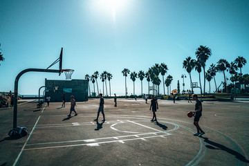 June 15, 2018. Los Angeles, USA. Basketball court at the Venice beach in Los Angeles. Beautiful summer spirit. Sport events by the ocean. © Aerial Film Studio