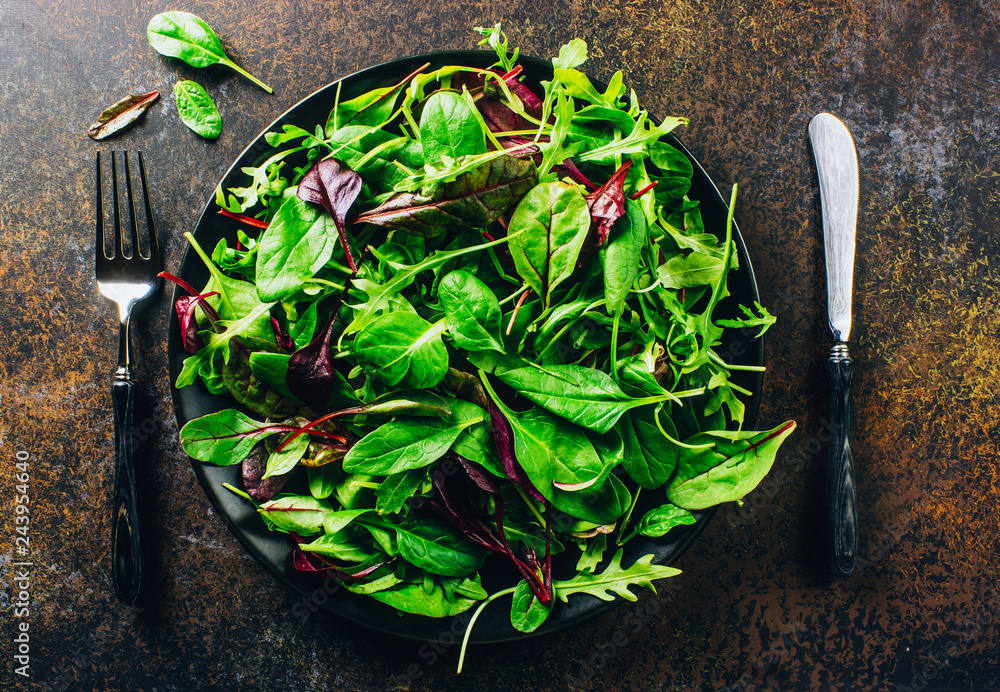 Wall mural Healthy food. Green meal. Fresh salad plate with mixed greens