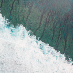Aerial shot of the braking wave at the ocean reef.