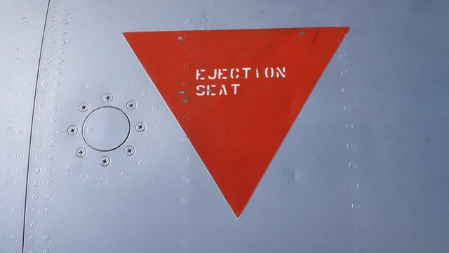 Red triangle indicating position of ejection seat on fighter jet. F-104 Starfighter.
