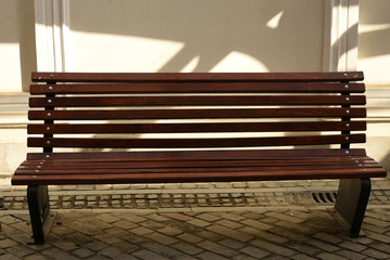 Wooden bench near a stone wall in Bistrita, ROMANIA