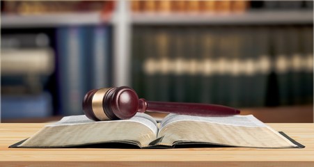 Book and wooden gavel on table. Justice concept